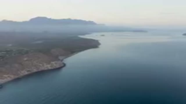 DANZANTE BAY LORETO BCS MEXICO-2023: Body Of Water With A Mountain In The Background