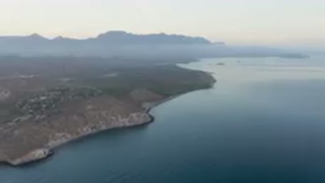 DANZANTE BAY LORETO BCS MEXICO-2023: Body Of Water With A Mountain In The Background