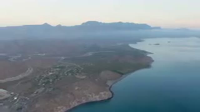 DANZANTE BAY LORETO BCS MEXICO-2023: Large Body Of Water With A Mountain In The Background