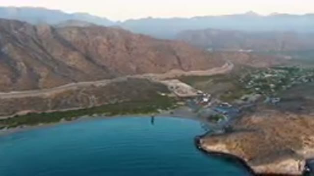 DANZANTE BAY LORETO BCS MEXICO-2023: Mountains And A Body Of Water With A Small Town