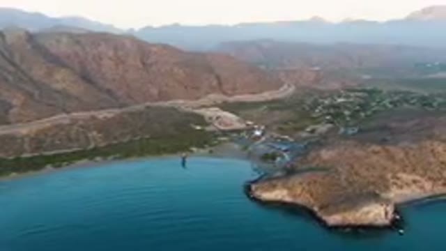 DANZANTE BAY LORETO BCS MEXICO-2023: Aerial Beach And A Mountain Range With A
