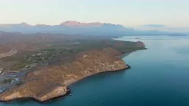 DANZANTE BAY LORETO BCS MEXICO-2023: Large Body Of Water With A Mountain In The Background