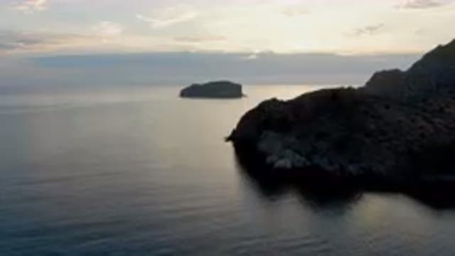 DANZANTE BAY LORETO BCS MEXICO-2023: Boat Sailing in Water Near Rocky Shoreline