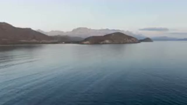 DANZANTE BAY LORETO BCS MEXICO-2023: Boat Floating On Calm Waters Near Mountains