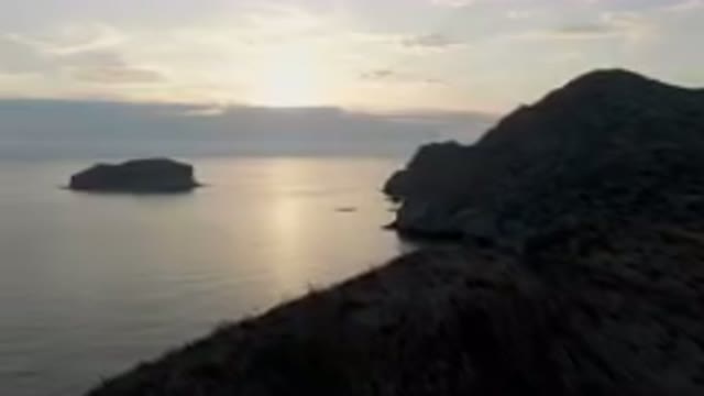DANZANTE BAY LORETO BCS MEXICO-2023: Body Of Water With A Rock Formation In The