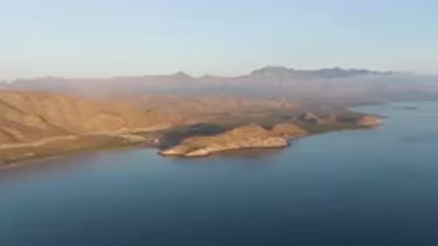 DANZANTE BAY LORETO BCS MEXICO-2023: Body Of Water With A Mountain In The Background