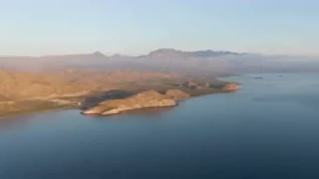 DANZANTE BAY LORETO BCS MEXICO-2023: Body Of Water With Mountains In The Background