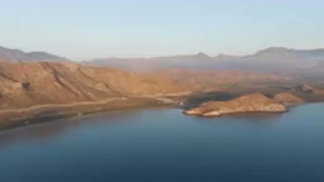 DANZANTE BAY LORETO BCS MEXICO-2023: Mountains And A Body Of Water With A Small Island