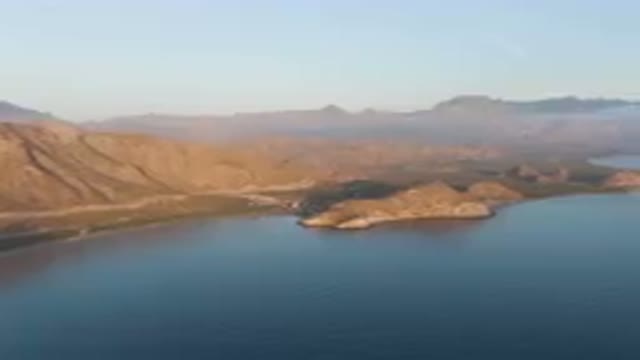 DANZANTE BAY LORETO BCS MEXICO-2023: Mountains And A Body Of Water With A Plane