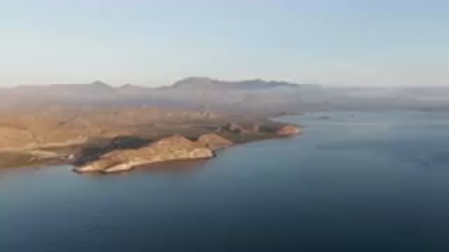 DANZANTE BAY LORETO BCS MEXICO-2023: Body Of Water With A Mountain In The Background