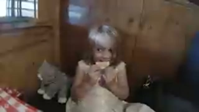 Little Girl Tasting her Orange Slice