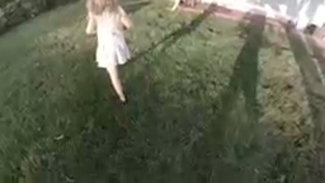 Little Girl Following her Dog