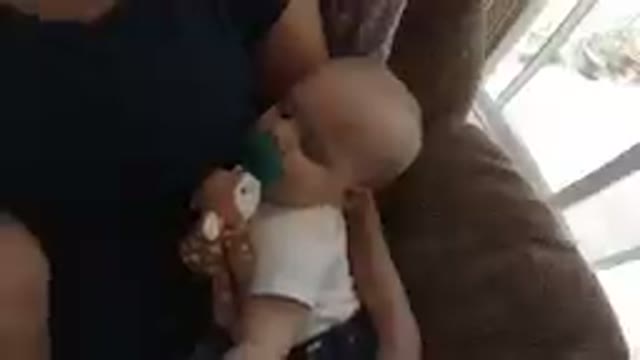 Cute Baby Boy Resting on his Mom's Lap