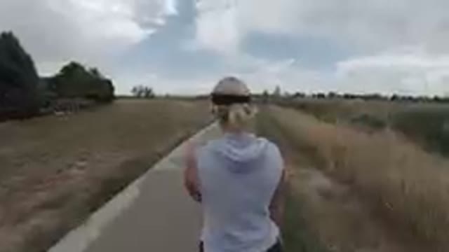 DENVER, UNITED STATES-2019: Back View Of Woman Walking Down A Path