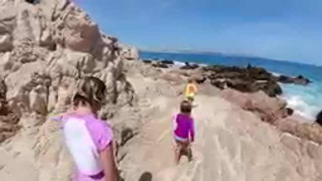 CABO BAJA CALIFORNIA SUR MEXICO-2019: Children Running Along Rocky Coastal Path