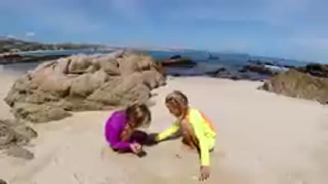 CABO BAJA CALIFORNIA SUR MEXICO-2019: Two Children Playing In Sand On Beach
