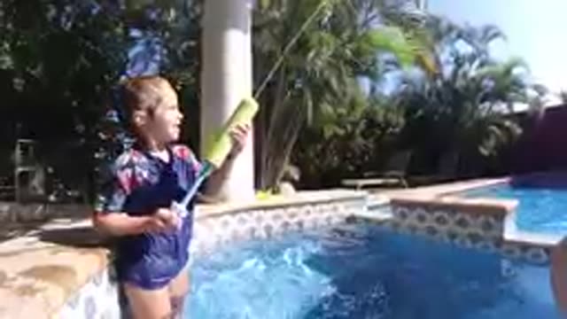 CABO BAJA CALIFORNIA SUR MEXICO-2019: Young Girl Playing With Water Gun By Pool