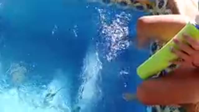 CABO BAJA CALIFORNIA SUR MEXICO-2019: Person Dipping Feet In Pool With Drink