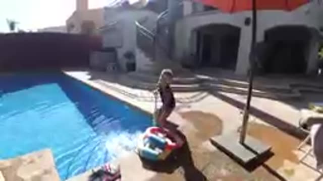 CABO BAJA CALIFORNIA SUR MEXICO-2019: Child Standing By Poolside With Inflatable Ring