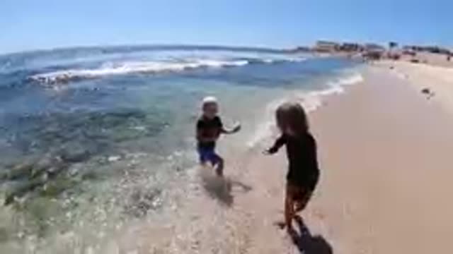 CABO BAJA CALIFORNIA SUR MEXICO-2019: Two Children Playing In Shallow Ocean Waves