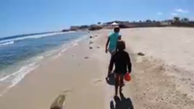 CABO BAJA CALIFORNIA SUR MEXICO-2019: Man And Child Walking Along Sandy Beach