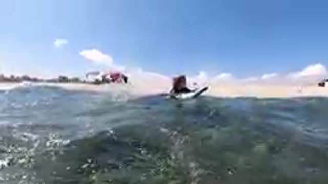 CABO BAJA CALIFORNIA SUR MEXICO-2019: Surfer Paddling Out In Shallow Ocean Water