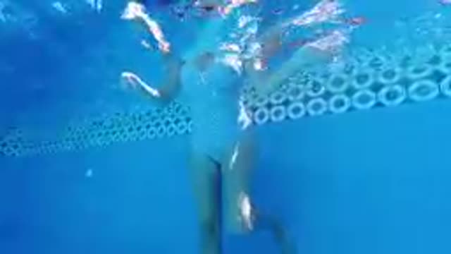 Woman In A Swim Suit Under Water In A Pool