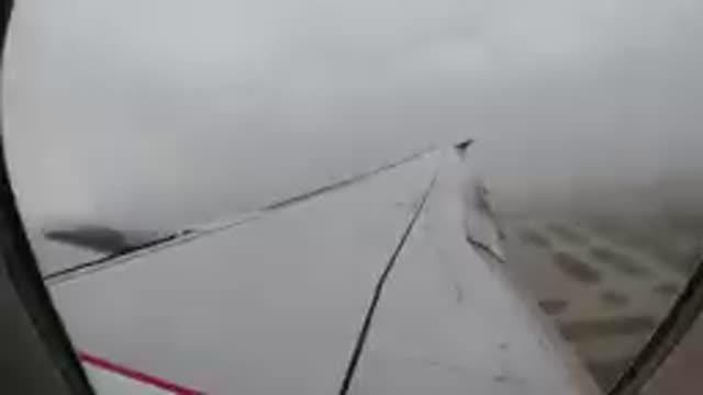 CHICAGO USA-2019: Airplane Wing View Through Window Over Clouds