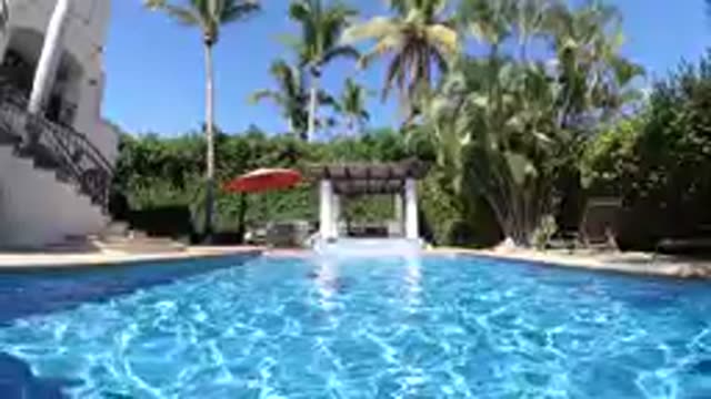 CABO BAJA CALIFORNIA SUR MEXICO-2019: Person Swimming In Tropical Resort Pool