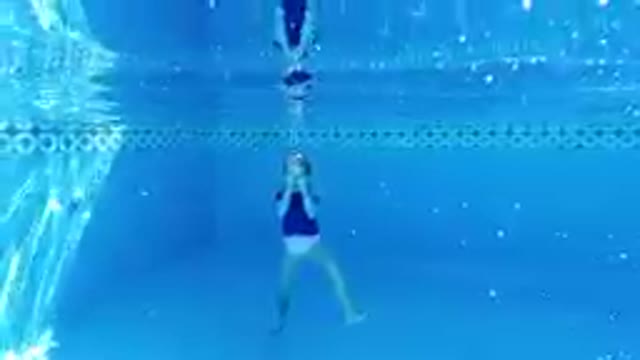 Woman Swimming In A Pool With A Blue Background