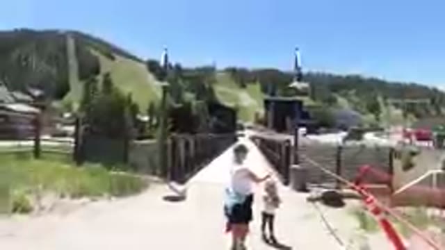 Woman And A Child That Are Standing On A Bridge