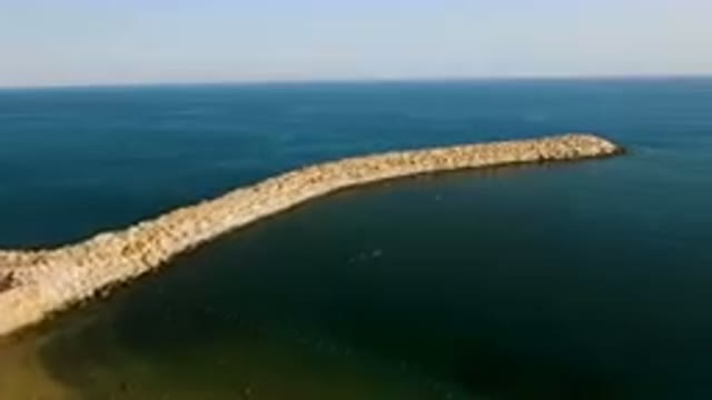 PUERTO LOS CABOS BCS MEXICO-2023: Large Body Of Water With A Stone Wall In The