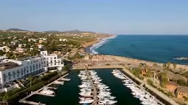 PUERTO LOS CABOS BCS MEXICO-2023: Boats Are Docked In A Marina Near A Beach And