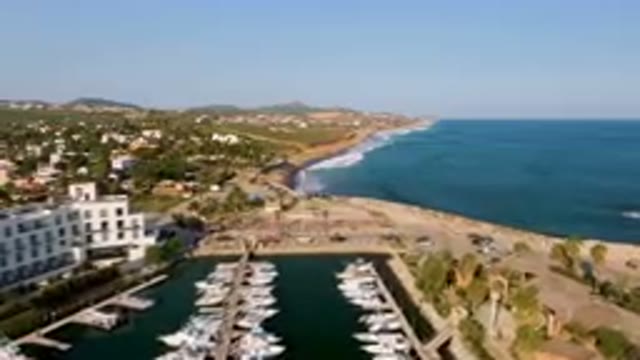 PUERTO LOS CABOS BCS MEXICO-2023: Boats Docked in Harbor Near City by Aerial Drone