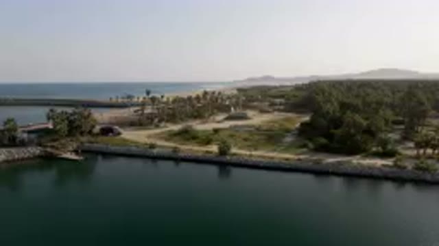 PUERTO LOS CABOS BCS MEXICO-2023: Large Body Of Water With A Small Island In The
