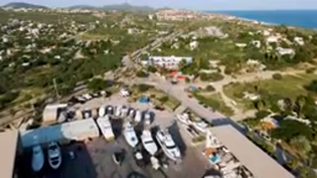 PUERTO LOS CABOS BCS MEXICO-2023: Boats Are Parked In A Lot Near A Beach And A