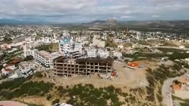 SAN JOSE DEL CABO BCS MEXICO-2023: Aerial View of Large Building Under Construction on a Hill