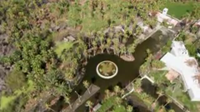 SAN JOSE DEL CABO BCS MEXICO-2023: Aerial Pond Surrounded By Palm Trees And A White House