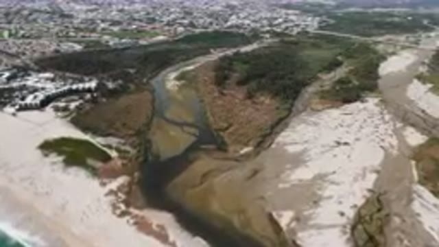 SAN JOSE DEL CABO BCS MEXICO-2023: Aerial River Running Through A Sandy Beach