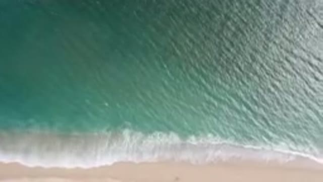 SAN JOSE DEL CABO BCS MEXICO-2023: Aerial Beach With A Surfboard And A Wave
