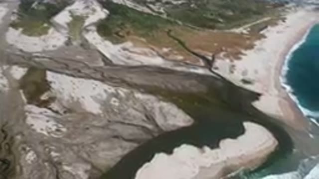 SAN JOSE DEL CABO BCS MEXICO-2023: Aerial River Running Through A Sandy Beach