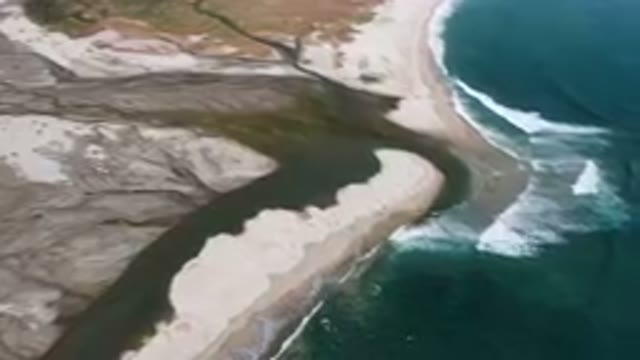 SAN JOSE DEL CABO BCS MEXICO-2023: Aerial River Running Through A Sandy Beach