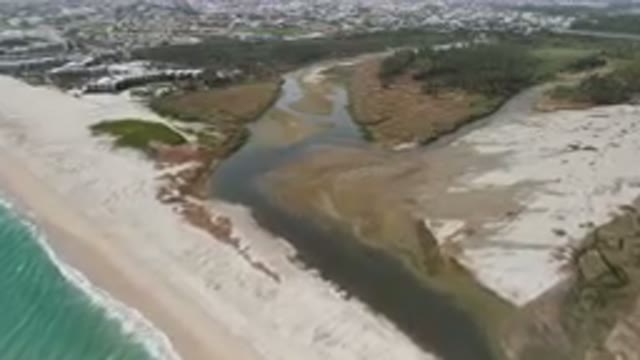 SAN JOSE DEL CABO BCS MEXICO-2023: Aerial River Running Through A Sandy Beach