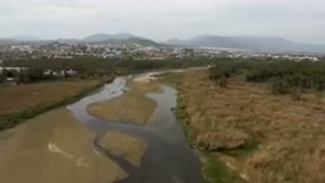 SAN JOSE DEL CABO BCS MEXICO-2023: River Running Through A Dry Grass Field