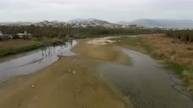 SAN JOSE DEL CABO BCS MEXICO-2023: River Running Through A Lush Green Field
