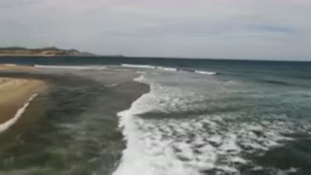 SAN JOSE DEL CABO BCS MEXICO-2023: Surfers Riding Waves On The Beach