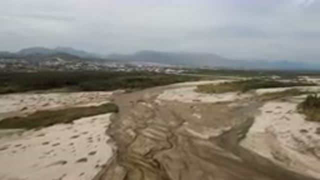 SAN JOSE DEL CABO BCS MEXICO-2023: River Running Through A Sandy Area