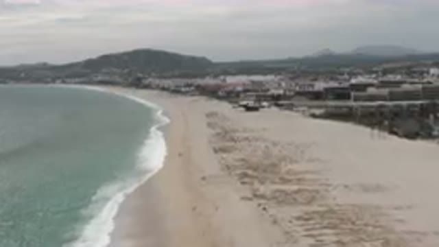 SAN JOSE DEL CABO BCS MEXICO-2023: Beach With A Lot Of Sand And A Few Buildings