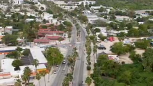 SAN JOSE DEL CABO BCS MEXICO-2023: City Street With A Few Cars Driving Down It