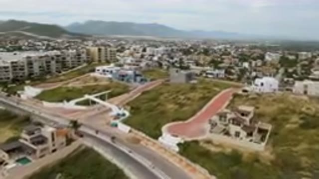 SAN JOSE DEL CABO BCS MEXICO-2023: Aerial City With A Plane Flying Over A Road